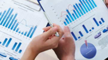 Sheets of paper with blue bar and circle graphs